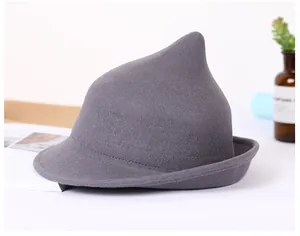 Macro detail of dark grey wool felt witch hat with pointed crown and curled brim edge