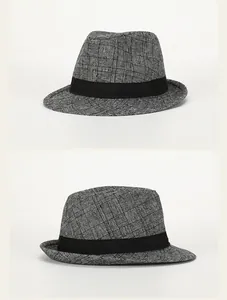 Detail of British style checkered fedora hat with black decorative band and textured fabric