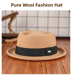 Close-up of camel pure wool fedora featuring a black ribbon and metal logo detail