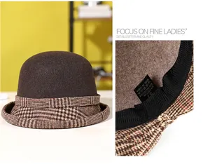 Detail of wool fedora showing plaid brim stitching and material labels with composition