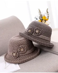 Detailed texture of thick wool knit cloche hat with houndsfoot pattern and 3D flower decor