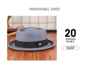 Detail of pure wool fedora hat with black grosgrain ribbon and gold emblem on wood