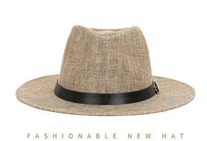 Detail of khaki linen fedora hat featuring black leather band and silver metal buckle