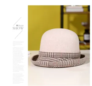 Detail of wool cloche hat with brown plaid brim edge in vintage British style