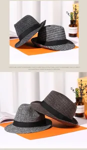 Detailed view of British plaid fedora hats in grey and brown wool blend fabric