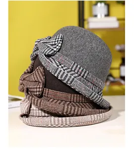Detail view of winter wool cloche hats showing bow tie textures and plaid patterns