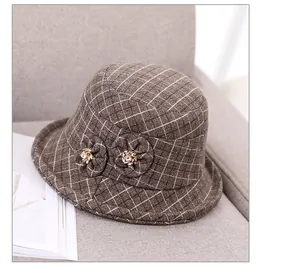 Detailed view of brown checkered wool bucket hat with elegant 3D floral accents
