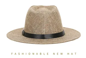 Close-up of brown linen fedora hat featuring woven texture and black leather decorative band