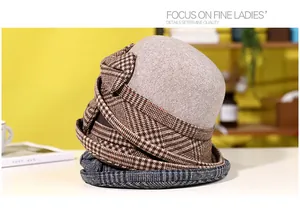 Detail of elegant wool felt bucket hat featuring stylish houndstooth bow decoration