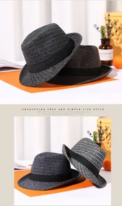 Detail of dark grey and brown plaid fedora hats with black ribbon and indented crown