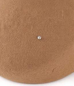 Close-up of pearl and rhinestone embellishments on the brown wool beret dome