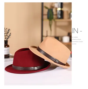 Detail of wool fedora hats in burgundy and khaki with leather bands and M-logo pins