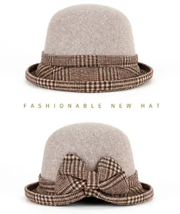 Close-up of light grey wool felt bucket hat featuring a stylish brown plaid bow decoration