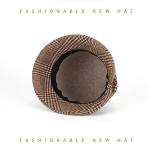 Detail view of the brown felt lining and black sweatband inside the plaid bucket hat