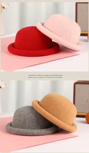 Detail of wool knit bucket hats in red, pink, camel and grey with rolled brims