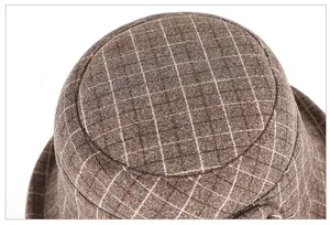 Top view detail of dark brown plaid wool bucket hat showing round crown construction