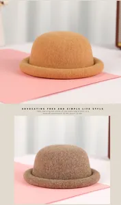Detail view of wool felt textures on camel and coffee knit rolled edge dome hats