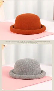 Close-up of winter wool felt bucket hats with rolled brims in burnt orange and light grey