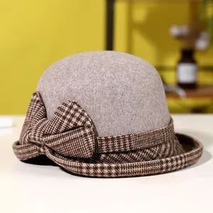 Elegant wool felt cloche hat in beige with houndstooth bow and brim for winter warmth