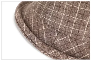 Close-up of brown plaid wool fabric texture and stitching on winter bucket hat