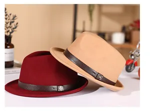 Detail view of wool fedora hats with leather bands and metal M logo accents
