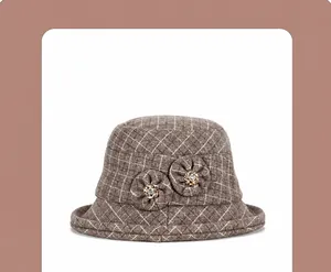 Detail of brown plaid wool bucket hat featuring decorative fabric flowers with crystals