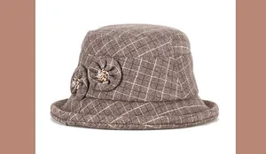Detailed view of the brown plaid wool bucket hat with decorative flowers and rhinestones