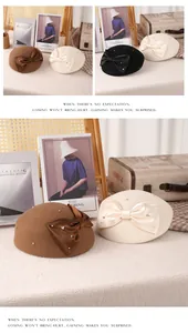 Detail of wool beret with large satin bow and delicate pearls in a vintage French style