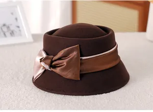 Detail of dark brown wool cloche hat with an elegant champagne and bronze silk bow ribbon