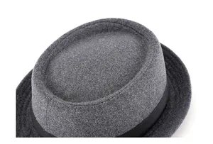 Detailed top view of dark grey wool felt pork pie hat with black grosgrain ribbon trim