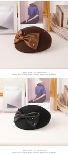 Detail of wool beret with silk bow and faux pearls decoration in brown and black