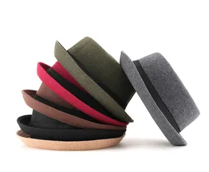 Stack of colorful wool felt bowler hats featuring side ribbon trim and rolled brims