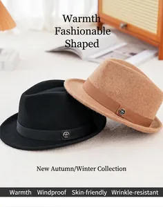 Detail of wool fedora hats in black and camel with metallic buckle and ribbon trim