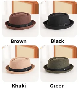 Detail view of four wool felt bowler hats in brown black khaki and green with metal tags