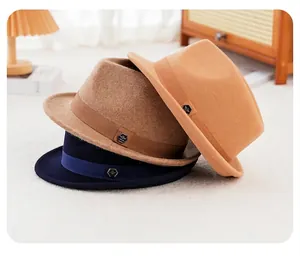 Three wool fedora hats in navy, brown, and tan with ribbon and metal crest detail