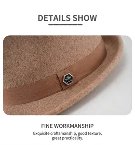 Detailed close-up of wool fedora hat featuring camel ribbon and metal shield emblem
