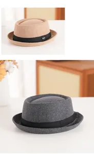 Detail of wool fedora hats in khaki and grey with black ribbon and metal logo buckle