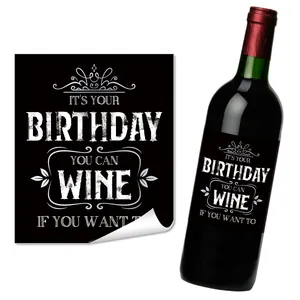 Detail showing self-adhesive black wine bottle sticker with funny birthday text and floral border