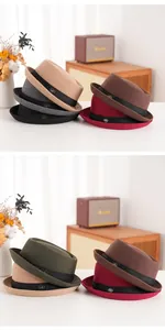 Detail view of multicolored wool felt fedora hats with grosgrain trim and metal badge