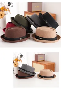 Detailed texture of wool felt pork pie hats with elegant ribbon and metal brand logo