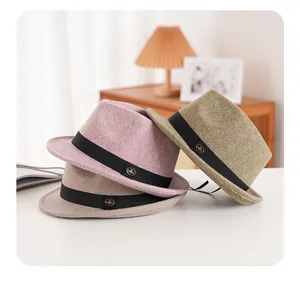 Three wool felt fedora hats in pink, khaki, and green with grosgrain ribbon and metal pin