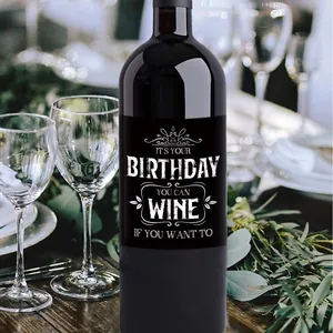 Detailed view of black birthday wine bottle labels with crown design and creative text