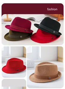 Detail of wool fedora hats featuring side fabric bands and hexagonal metal logos