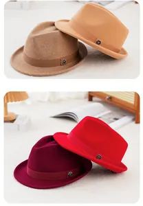 Detail of wool fedora hats in camel, brown, red, and burgundy with metal logo