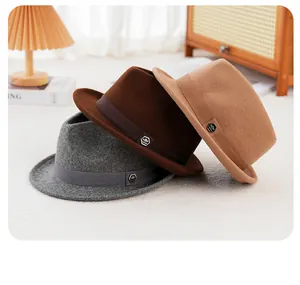 Detailed texture of pure wool fedora hats in grey, dark brown, and camel shades