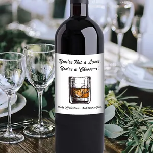 Funny Father's Day wine bottle labels with humorous quotes on a rustic wood table