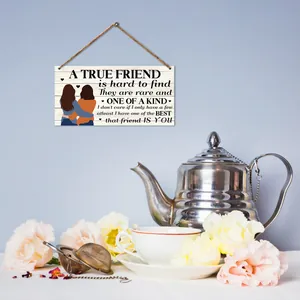 Rustic wood plaque wall decor featuring friendship quotes and illustration in tea room