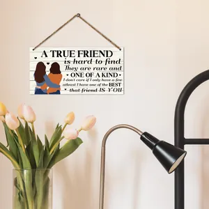 Close-up of rustic wooden friendship plaque with illustration and hanging jute rope
