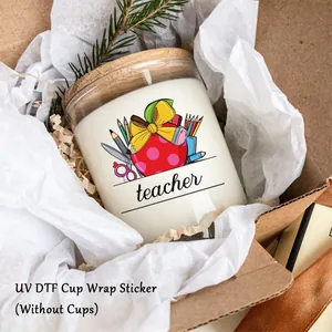 Close-up of UV DTF cup wrap sticker with teacher apple design on a glass jar