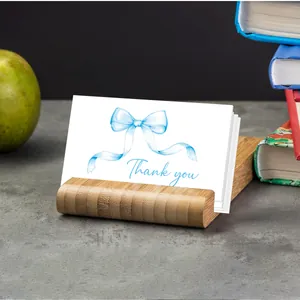 Detail of wooden card holder stand with elegant watercolor bow thank you cards